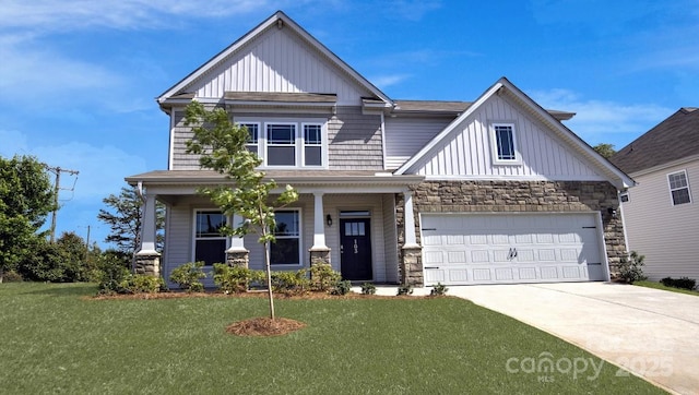 craftsman-style home featuring a porch, a front yard, and a garage