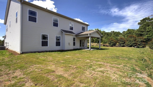 rear view of property with a lawn and central AC unit