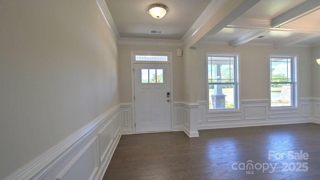 foyer entrance with beamed ceiling, crown molding, and dark hardwood / wood-style floors