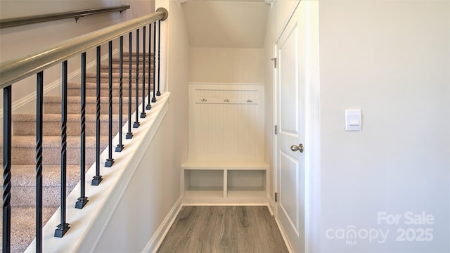 staircase with hardwood / wood-style flooring