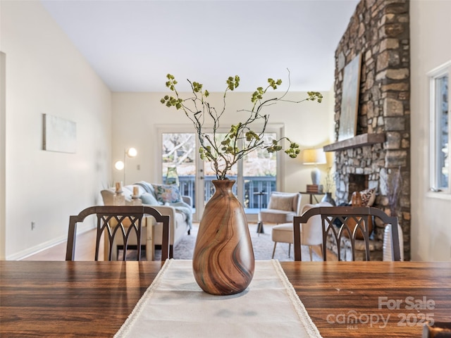 10 Clubside Dr, Asheville, NC 28804 - dining space featuring a stone fireplace, wood finished floors, and baseboards