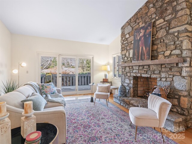 10 Clubside Dr, Asheville, NC 28804 - living room featuring a stone fireplace, vaulted ceiling, and wood finished floors