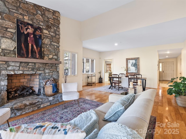 10 Clubside Dr, Asheville, NC 28804 - living room featuring a stone fireplace, baseboards, and wood finished floors