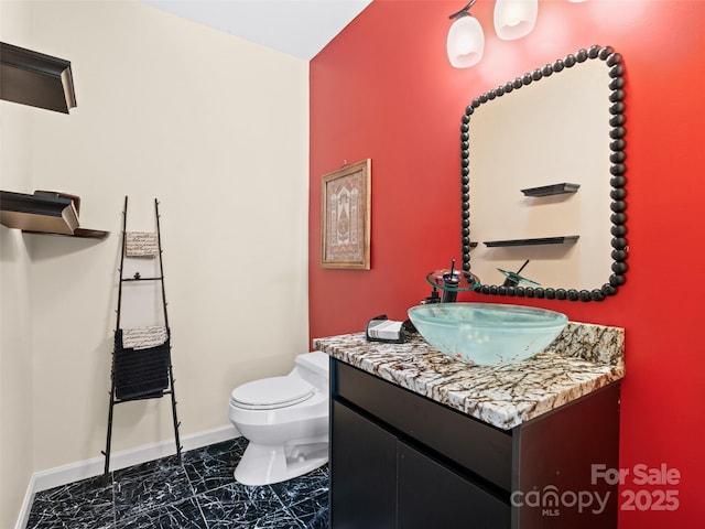 10 Clubside Dr, Asheville, NC 28804 - half bathroom featuring vanity, marble finish floor, baseboards, and toilet