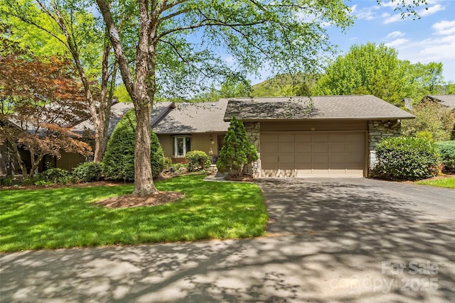 ranch-style home with a garage and a front lawn