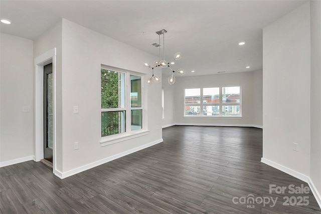 interior space with dark hardwood / wood-style flooring and a notable chandelier