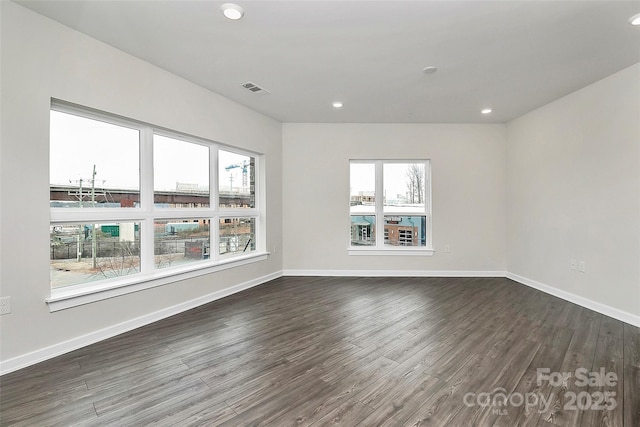 spare room with dark hardwood / wood-style flooring