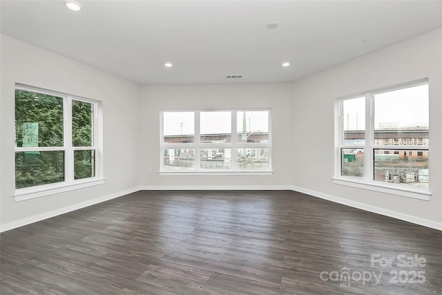 spare room featuring dark wood-type flooring