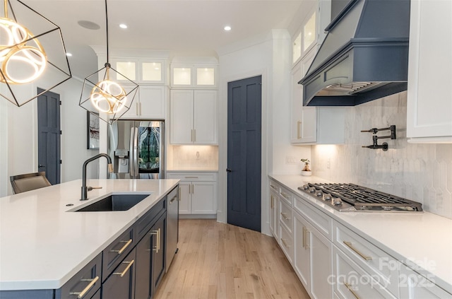 kitchen featuring appliances with stainless steel finishes, white cabinets, and sink