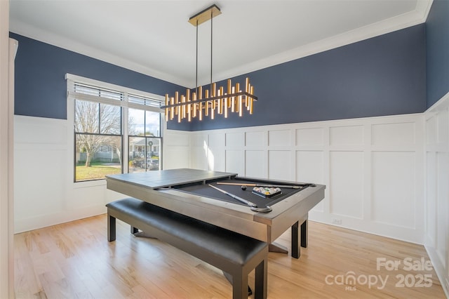 game room with billiards, crown molding, and light wood-type flooring