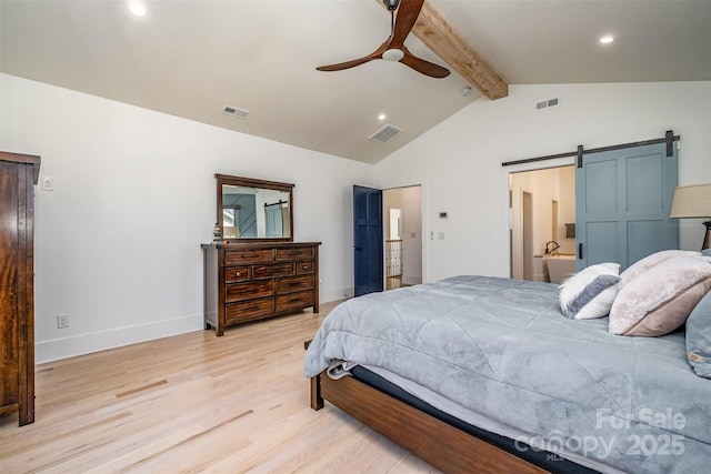 bedroom featuring connected bathroom, vaulted ceiling with beams, light wood-type flooring, ceiling fan, and a barn door