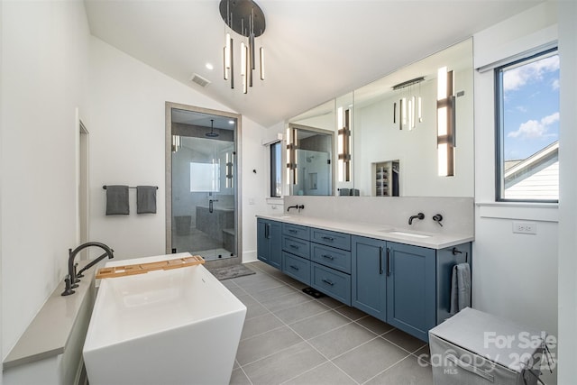 bathroom with vaulted ceiling, tile patterned floors, separate shower and tub, and vanity