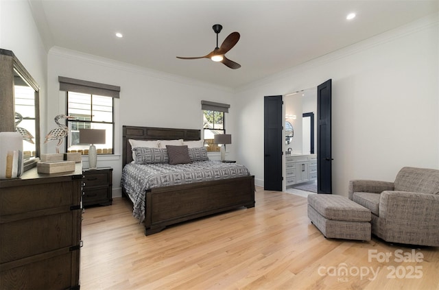 bedroom featuring ceiling fan, ensuite bathroom, crown molding, and light hardwood / wood-style floors