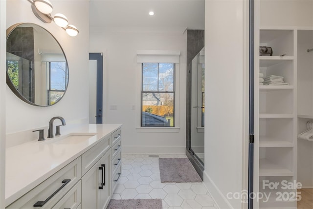 bathroom with vanity, tile patterned floors, a shower with door, and crown molding