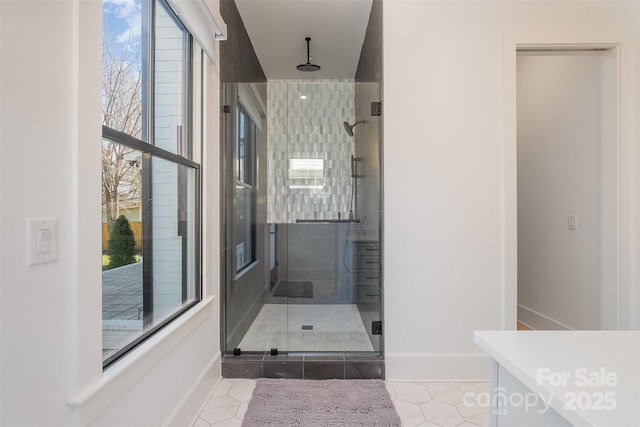 bathroom featuring an enclosed shower and tile patterned flooring