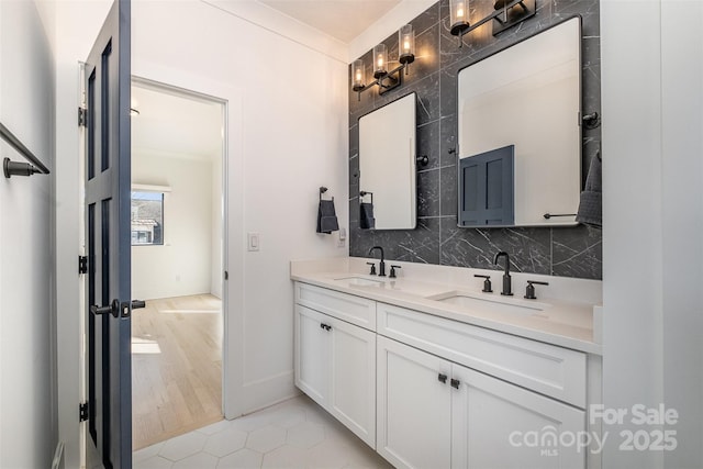 bathroom with crown molding, vanity, tasteful backsplash, and tile patterned flooring