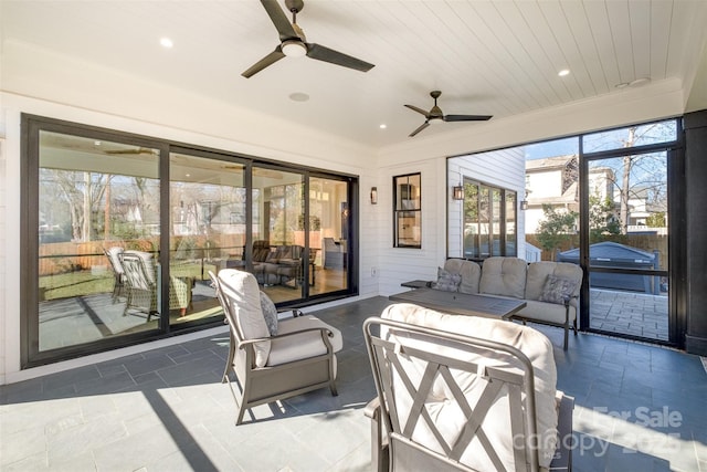 view of patio with ceiling fan and outdoor lounge area