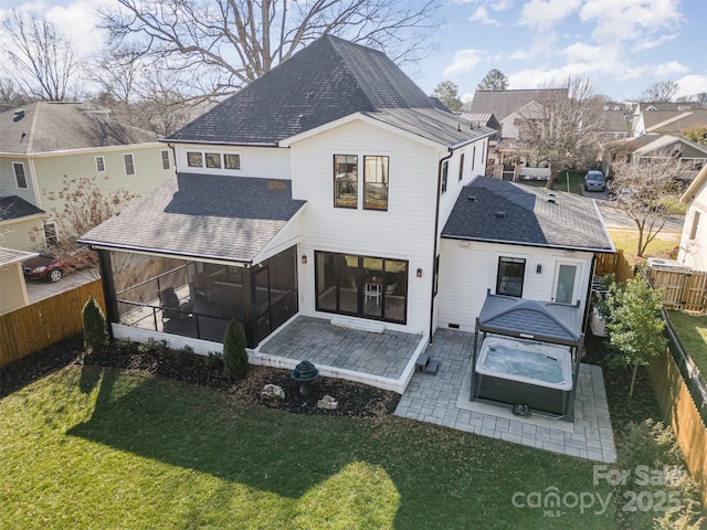 back of house with a sunroom, a lawn, and a patio