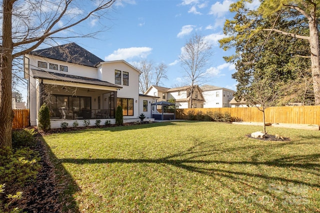 view of yard featuring a gazebo and a sunroom