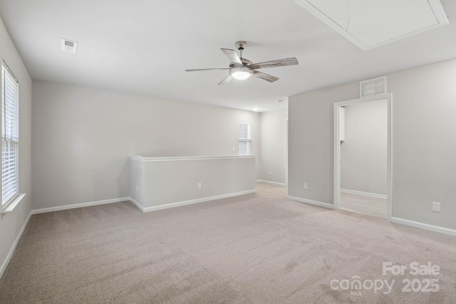 empty room featuring ceiling fan and light colored carpet