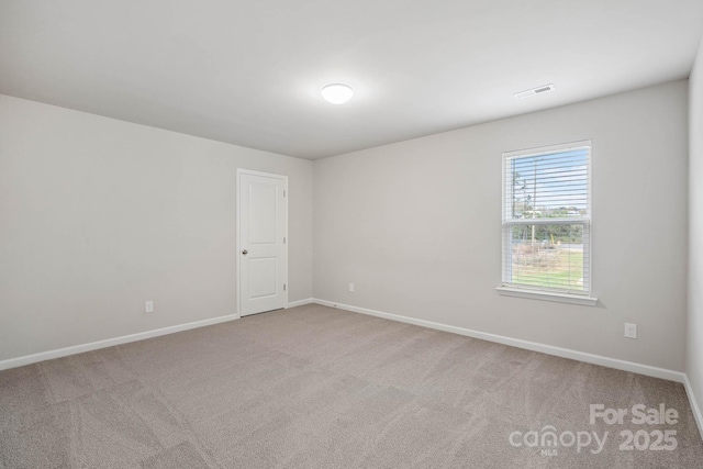 unfurnished room with light colored carpet