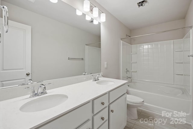 full bathroom featuring  shower combination, vanity, and toilet