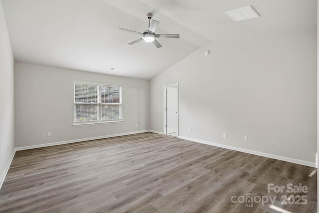 spare room featuring lofted ceiling, ceiling fan, and wood-type flooring