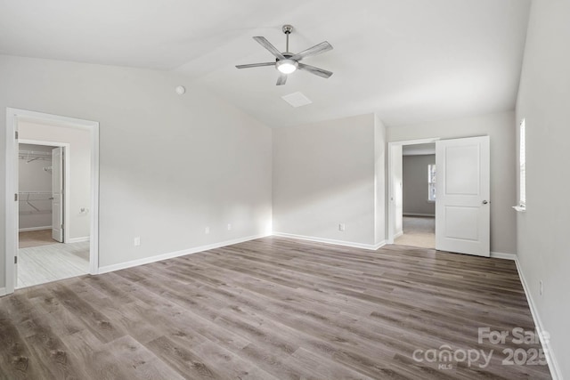 spare room with light hardwood / wood-style floors, ceiling fan, and vaulted ceiling