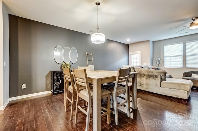 dining area with ceiling fan and dark hardwood / wood-style floors