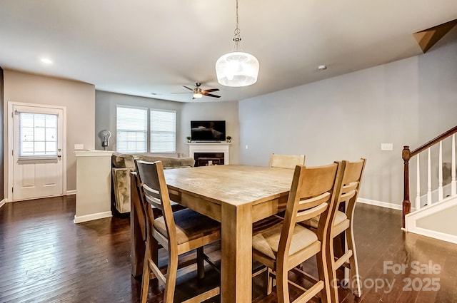 dining space with ceiling fan and dark hardwood / wood-style floors