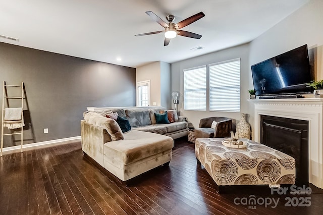 living room featuring ceiling fan and dark hardwood / wood-style floors