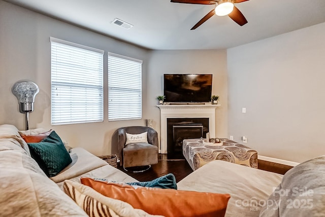 living room with ceiling fan and wood-type flooring