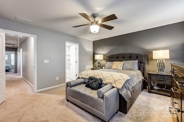 carpeted bedroom with ceiling fan and connected bathroom