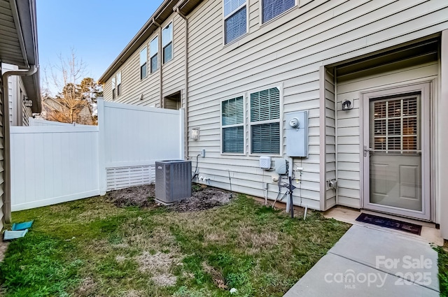 exterior space featuring a lawn and central AC