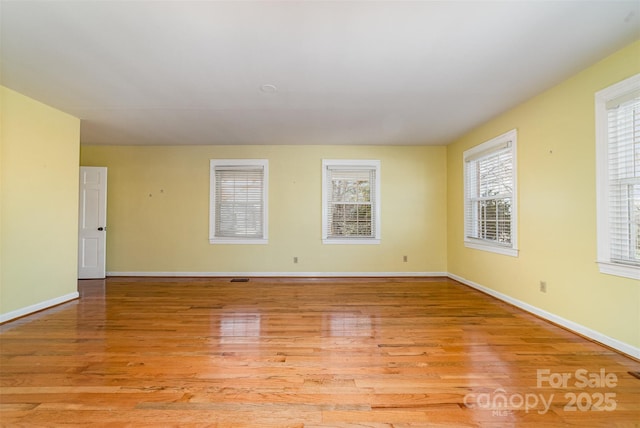 spare room featuring light hardwood / wood-style flooring