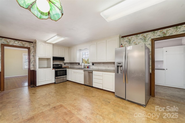 kitchen featuring sink, white cabinetry, appliances with stainless steel finishes, and crown molding