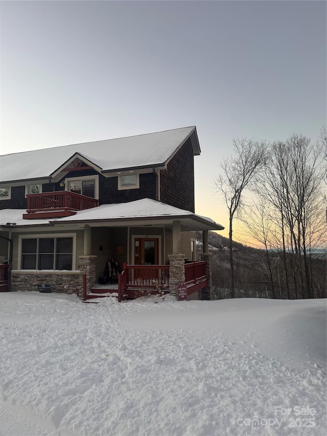 view of front of home featuring covered porch and a balcony