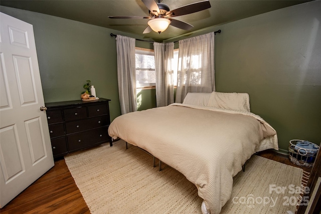 bedroom featuring ceiling fan and dark hardwood / wood-style flooring