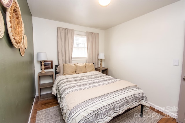 bedroom with dark hardwood / wood-style floors