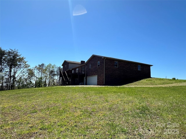 view of home's exterior with a garage, a wooden deck, and a yard