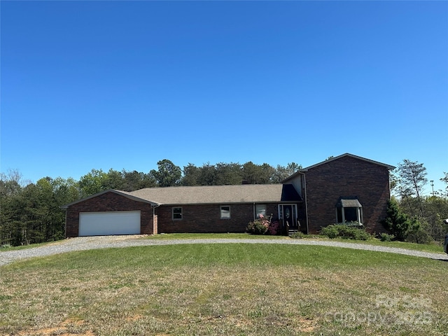 single story home featuring a front lawn and a garage