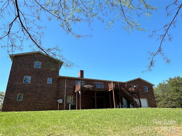 back of house featuring a wooden deck, central air condition unit, and a lawn