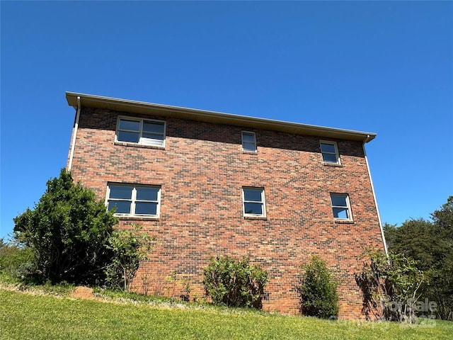 view of property exterior with a yard