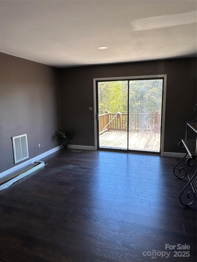 spare room featuring dark hardwood / wood-style flooring