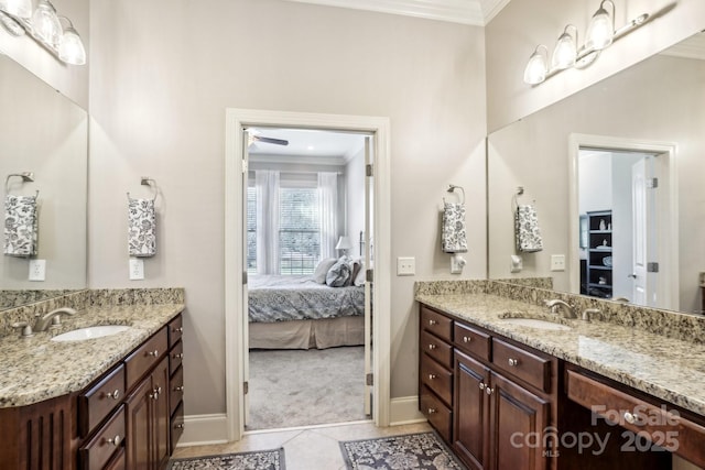 bathroom featuring tile patterned flooring, crown molding, and vanity