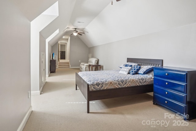 carpeted bedroom featuring ceiling fan and vaulted ceiling