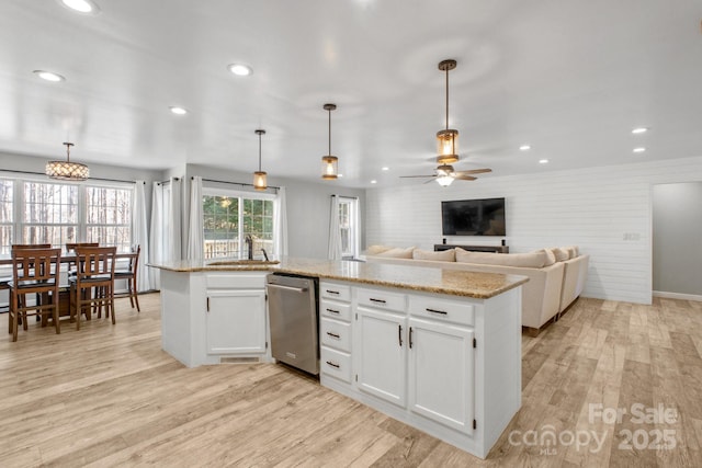 kitchen with ceiling fan, white cabinetry, stainless steel dishwasher, and decorative light fixtures