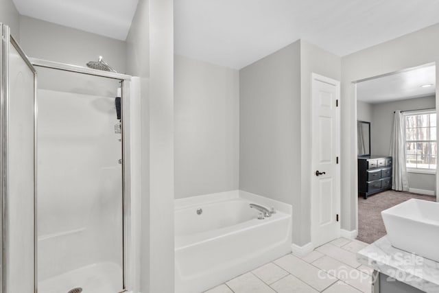 bathroom featuring vanity, tile patterned floors, and plus walk in shower