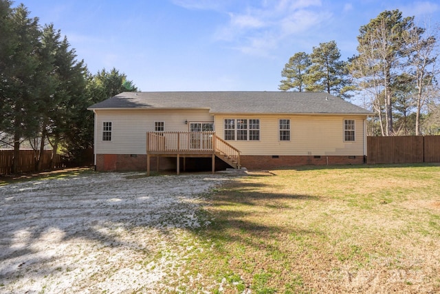 rear view of property with a deck and a yard