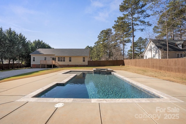 view of swimming pool with a wooden deck and an in ground hot tub